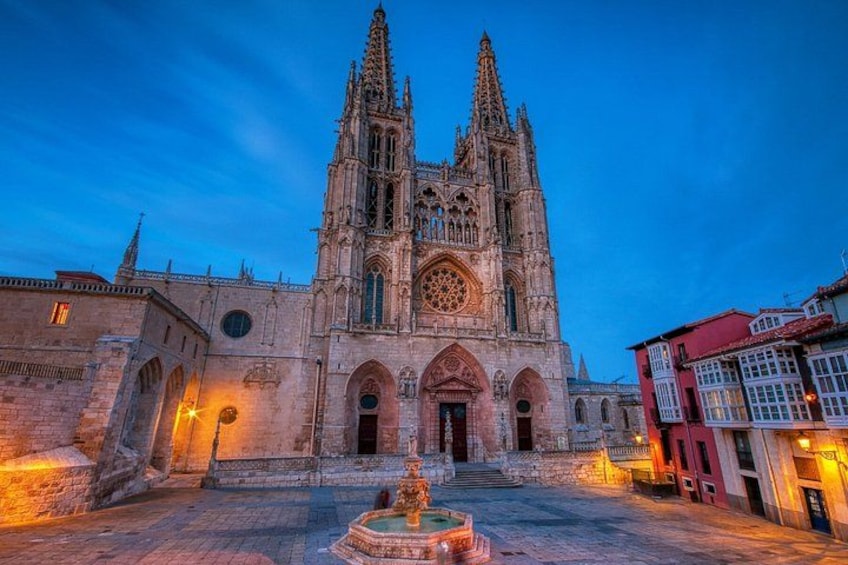 A Gothic cathedral with twin spires, a central rose window, and a fountain in the foreground. 4