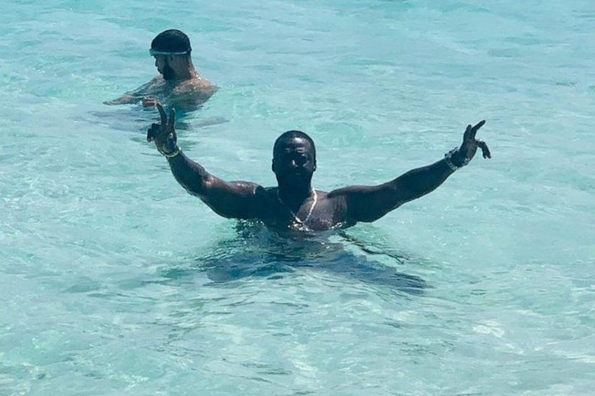 Two people swimming in clear blue water. 4