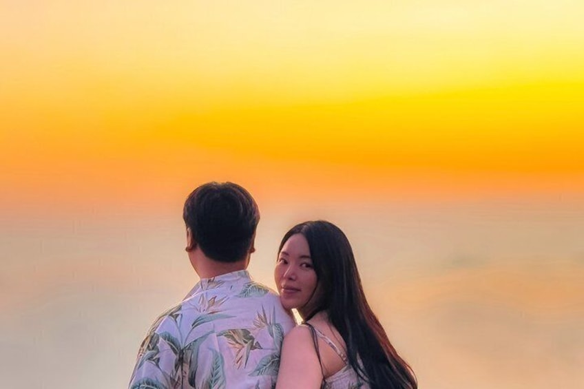 A couple embracing against a sunset with a gradient sky. 2