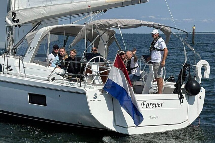 A sailboat named 'Forever' with a Dutch flag, sailing on water. 1
