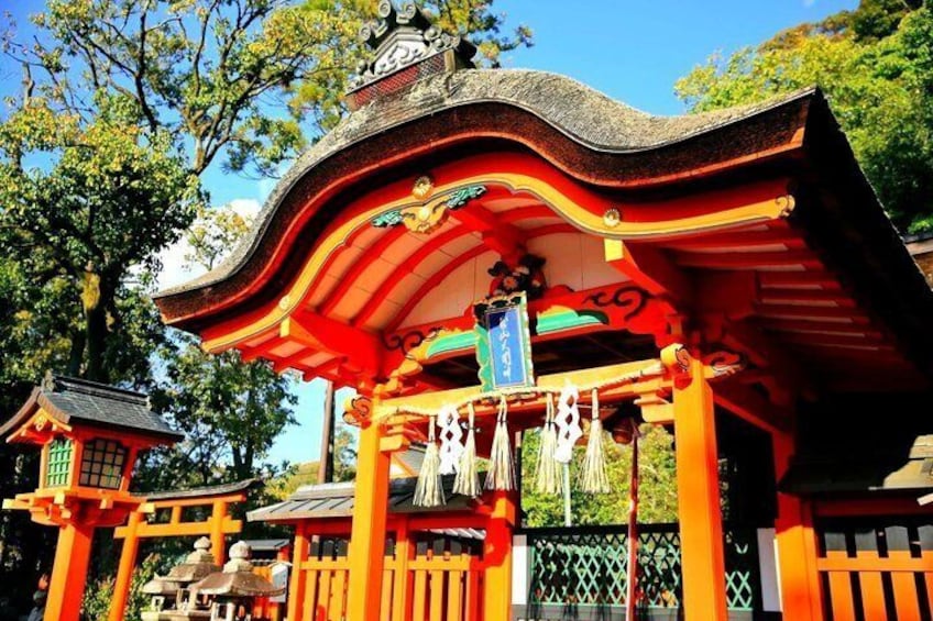 A traditional Japanese torii gate with a curved roof, surrounded by lush greenery and trees. 2