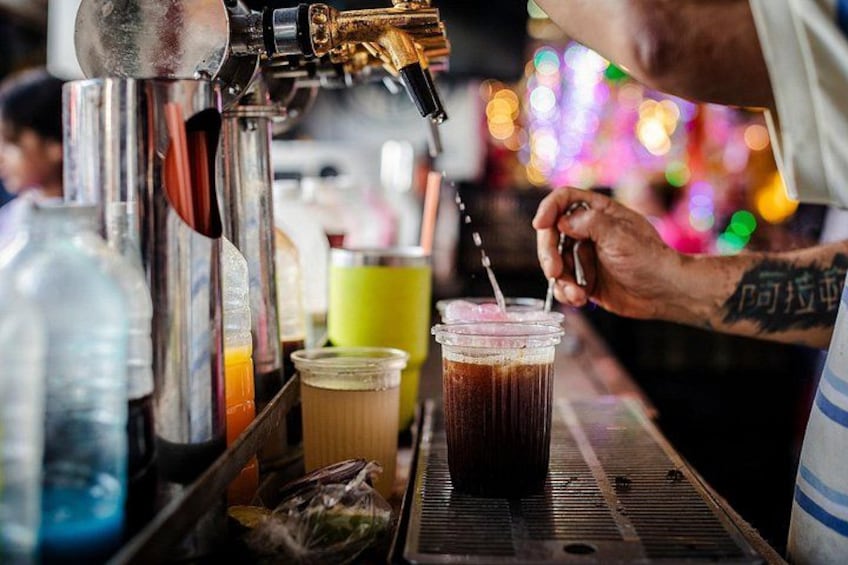 Un barista prepara una bevanda con una macchina da caffè e un bicchiere. 4
