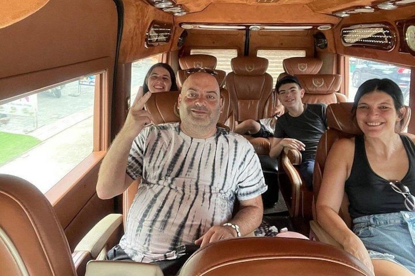 A bus interior with leather seats and a steering wheel. 4