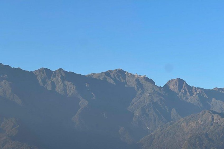 A mountain range with rugged peaks under a clear sky. 3