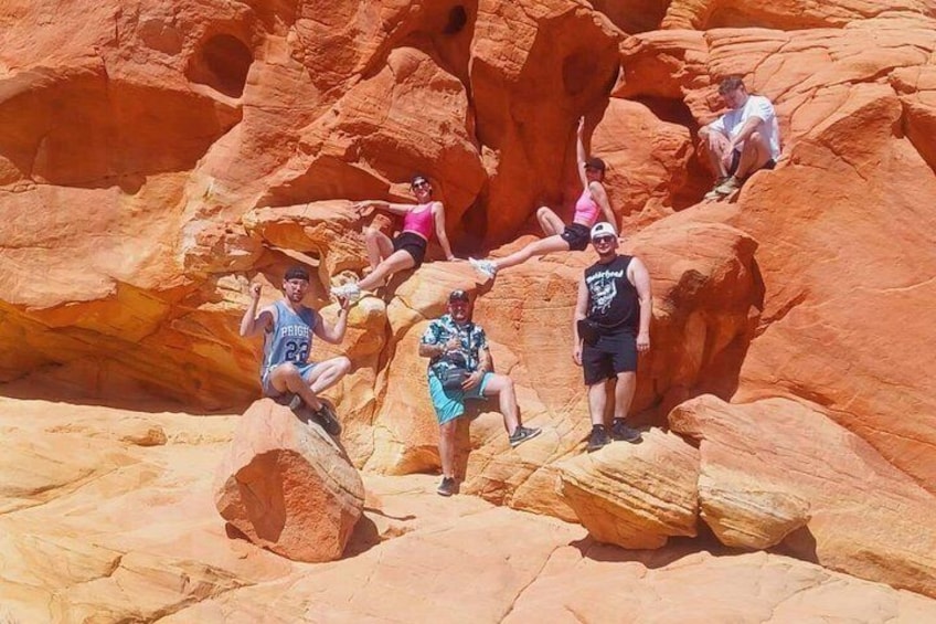 People sitting on rocks in a red rock canyon. 3