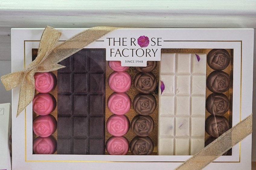 A gift box with chocolates and a ribbon. 2