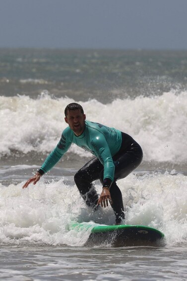 A person surfing on a wave. 5