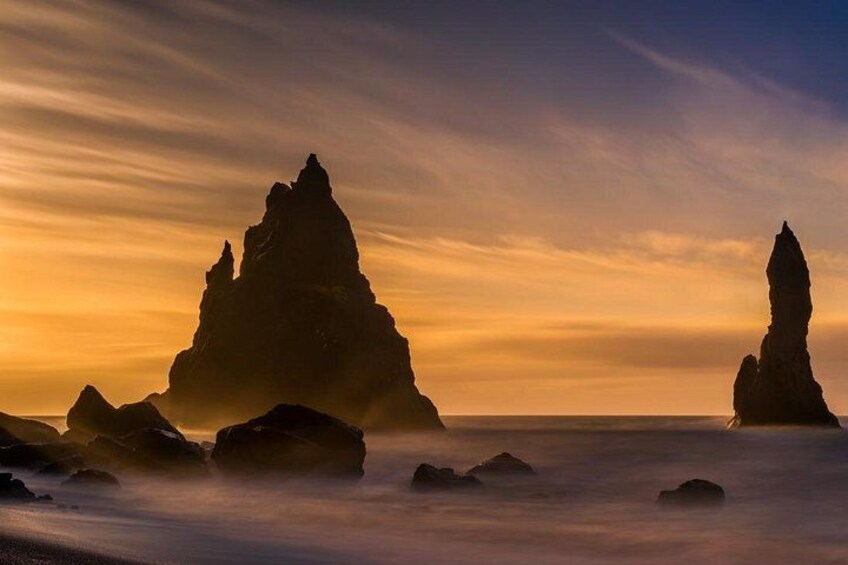 A coastal landscape with rock formations at sunset. 3
