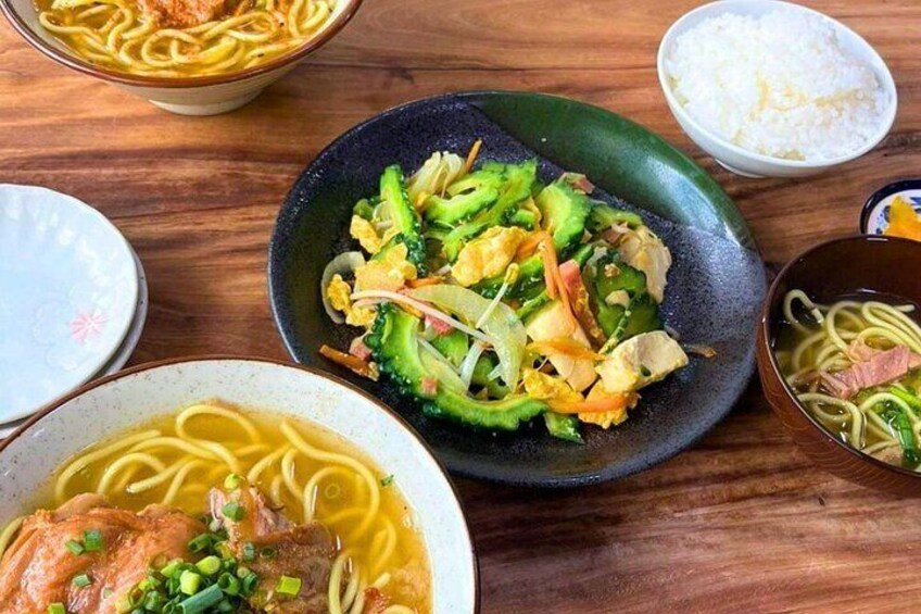 A variety of Asian dishes including noodles, stir-fried vegetables, and a bowl of soup. 4