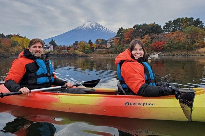 Two people kayaking on a calm lake with a mountain in the background. 4