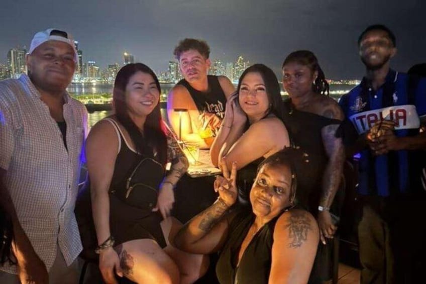 A group of people posing with a city skyline in the background. 5