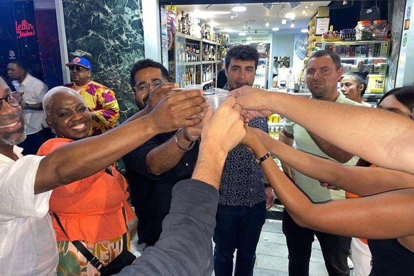 A group of people in a store with shelves stocked with various products. 5