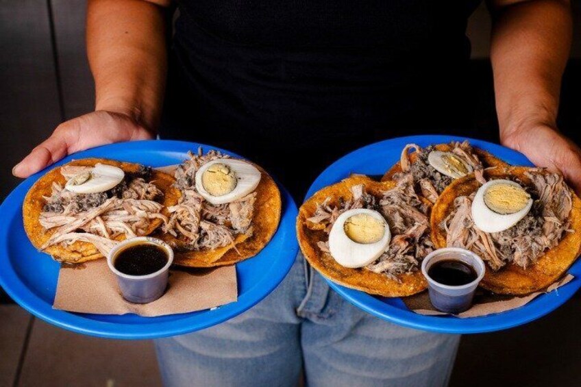 Due piatti blu con cibo, uno con una tazza di salsa. 1