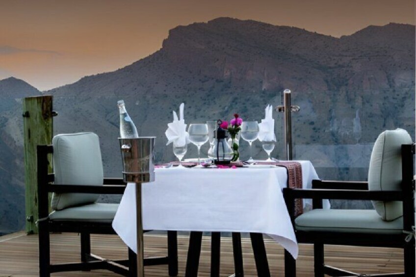 A table set for two with a mountain backdrop. 5