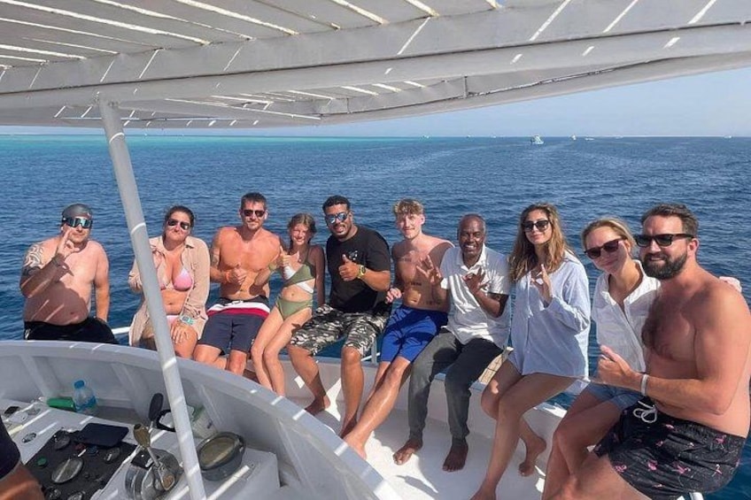 A group of people on a boat with the ocean in the background. 2