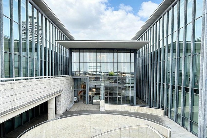 A modern building with large glass windows and a central atrium. 4