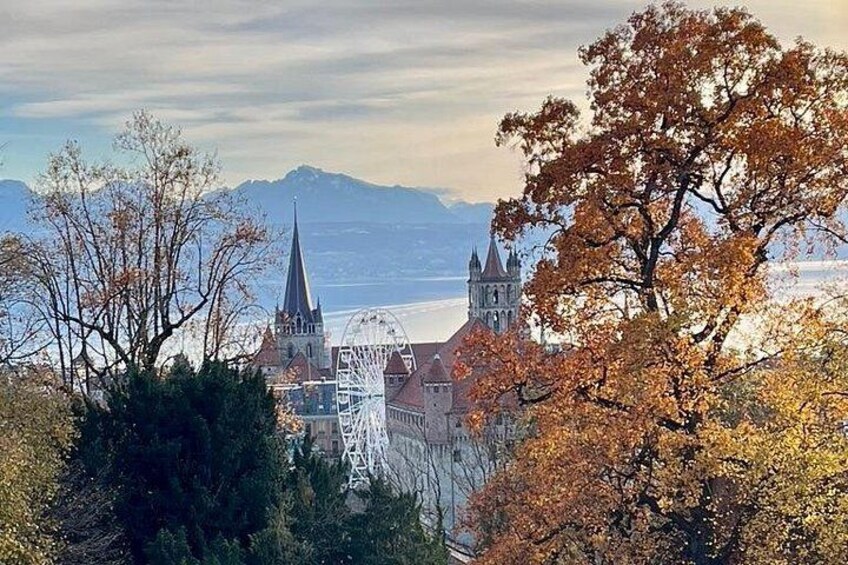 A town with a church, a Ferris wheel, and autumn-colored trees. 2