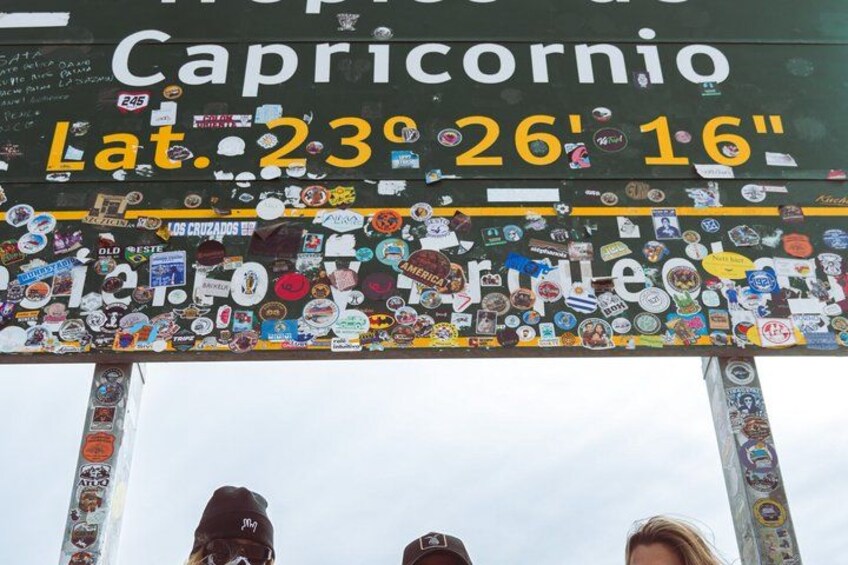 A sign with stickers, text, and a partially visible sky. 2