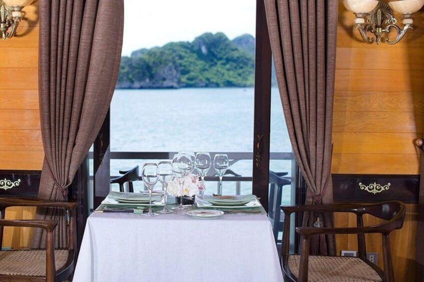 A table set for dining with a scenic view of a lake and mountains. 2