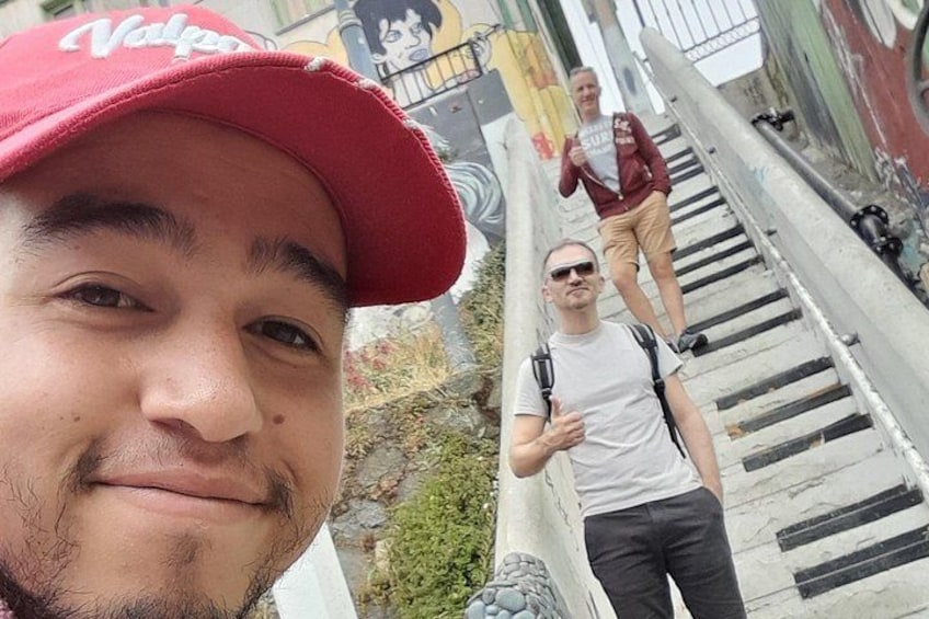 A person wearing a red cap and a white t-shirt taking a selfie. 4