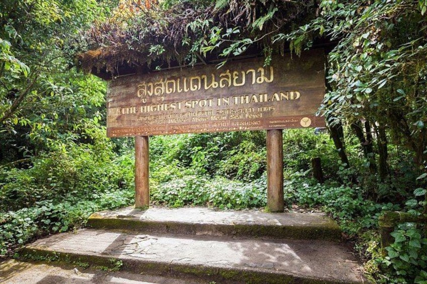 A stone sign with Thai text indicating a high elevation point in Thailand. 2