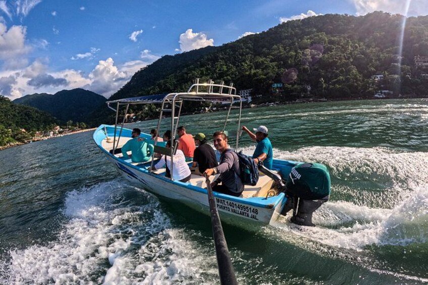 A boat with people on a river surrounded by hills. 5
