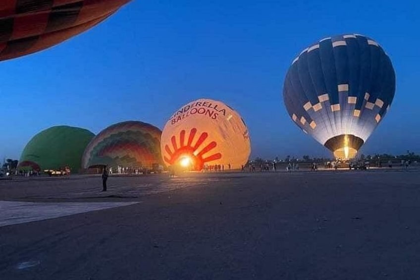 Hot air balloons at dusk with illuminated interiors. 4