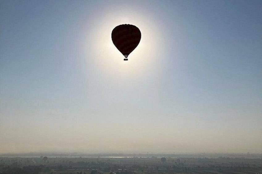 A hot air balloon with the sun in the background. 2