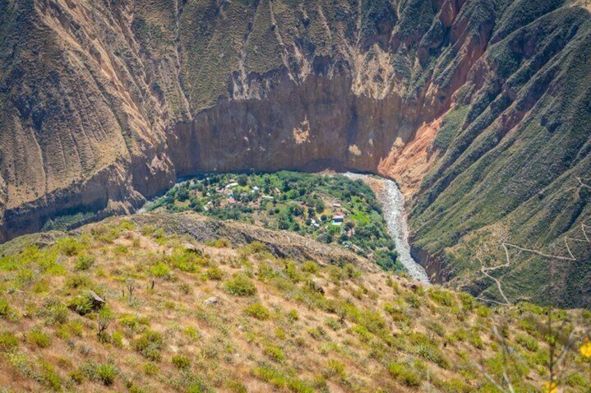 A river valley with a small settlement nestled among steep hills. 3