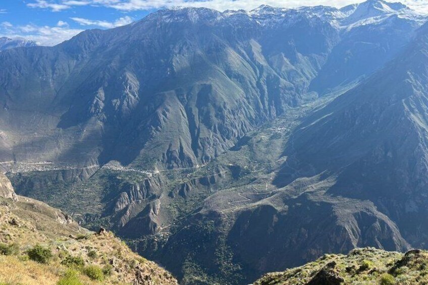 A mountainous landscape with a valley and a road. 5