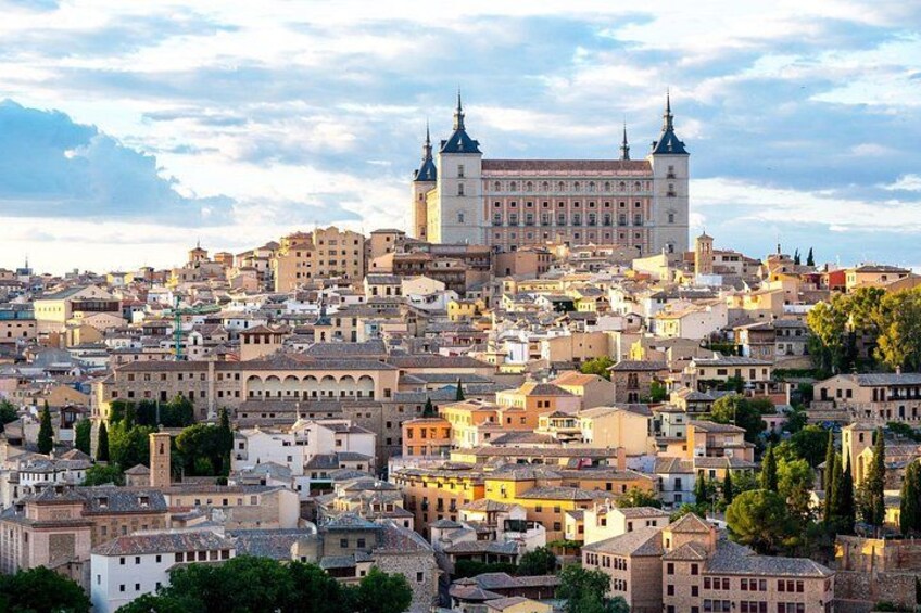 A cityscape with a prominent historical building with two spires, surrounded by densely packed urban buildings. 4