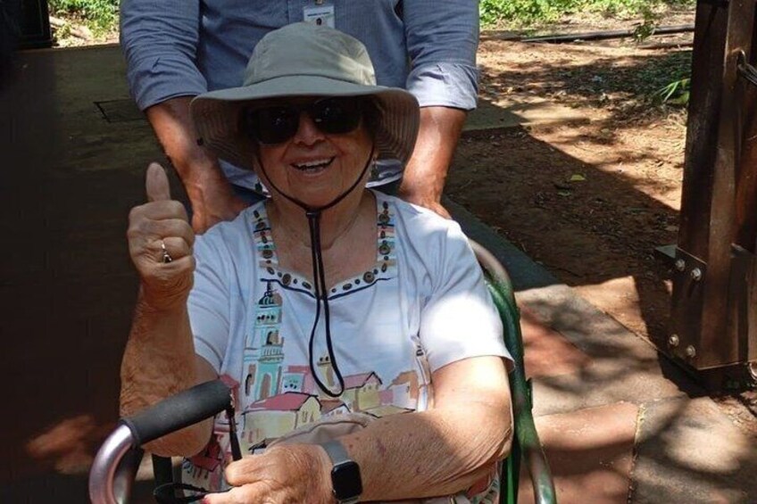 A person in a wheelchair giving a thumbs-up gesture. 4