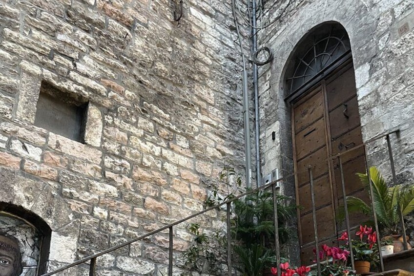 A stone building with a wooden door and a small window. 2