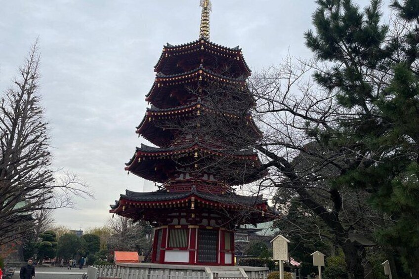 A multi-tiered pagoda with traditional architecture, surrounded by trees and a clear sky. 3
