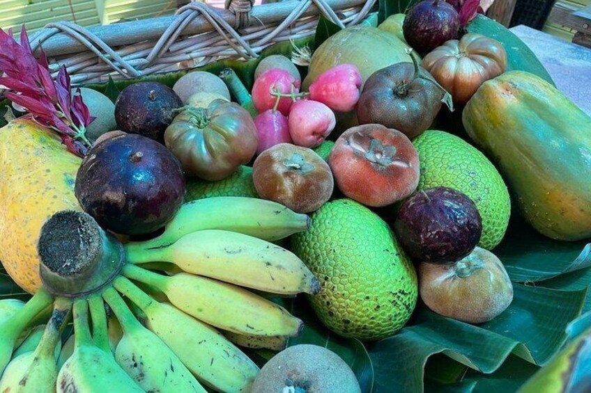 A variety of fruits including bananas, mangoes, and tomatoes. 5