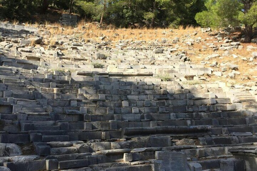 Ancient stone ruins with stepped structures and scattered stones. 5