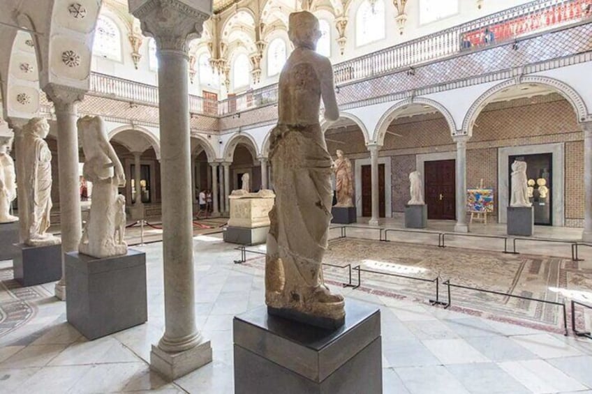 A historical building with classical statues and arches. 3