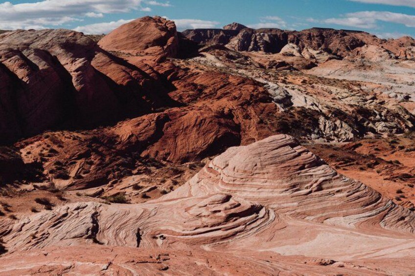 A rugged landscape with layered rock formations and a clear sky. 4