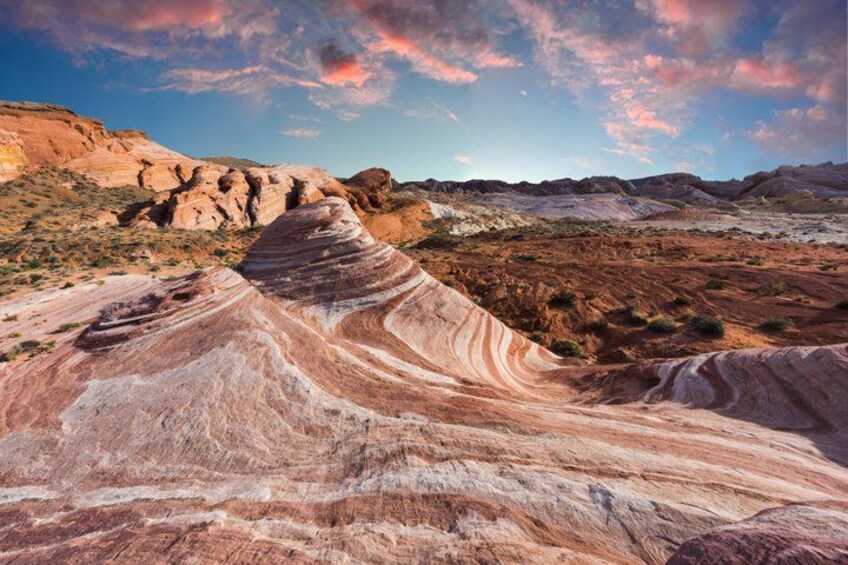 A desert landscape with layered rock formations and a clear sky. 3