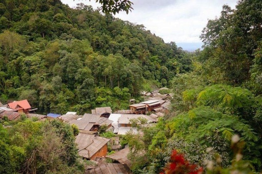A village nestled in a forested valley with traditional houses. 2