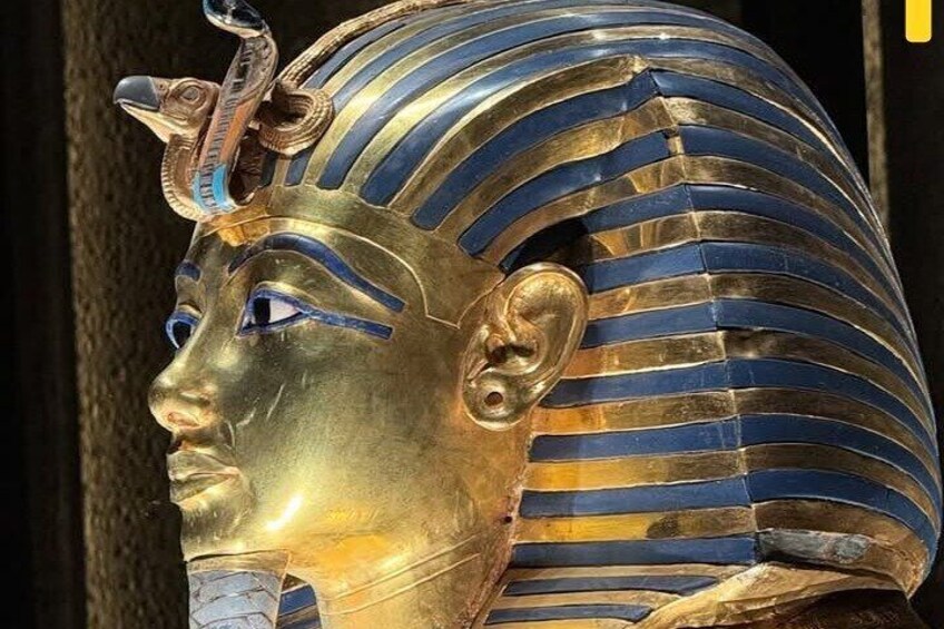 A golden bust with blue and gold stripes, a cobra head, and a cobra figure on the crown. 1