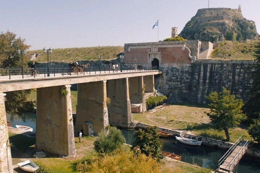 A bridge over a river, a fort on a hill, and a flag. 3
