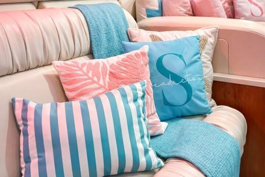 A sofa with colorful striped pillows and a blanket. 5