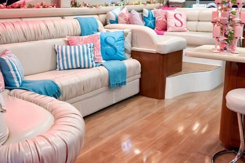 A modern living room with a beige sofa, pink and blue cushions, and a wooden coffee table. 3