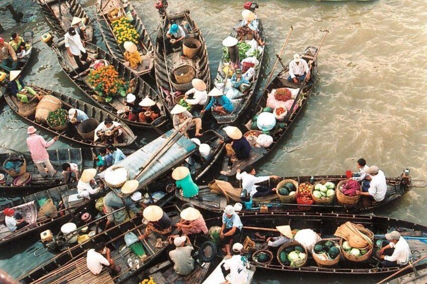 A crowded river with numerous traditional boats carrying various goods. 4