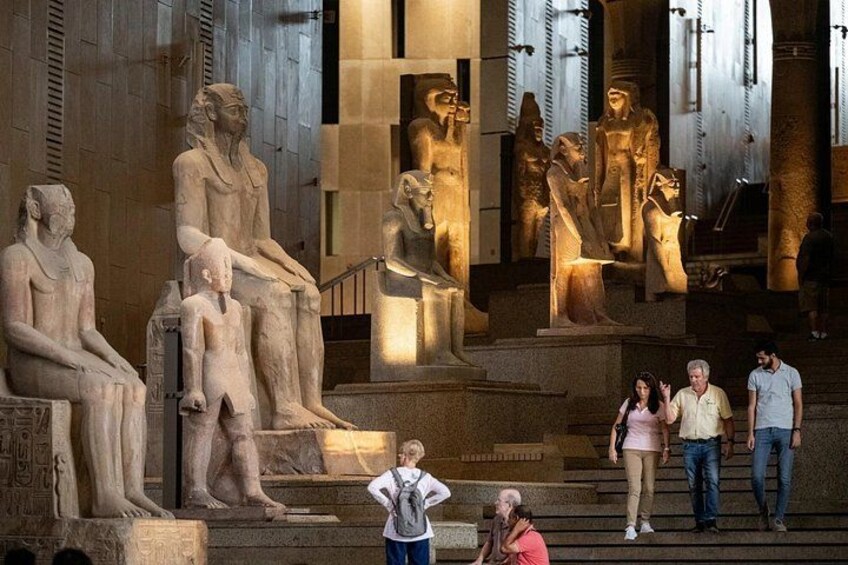 Ancient Egyptian statues in a museum setting. 4