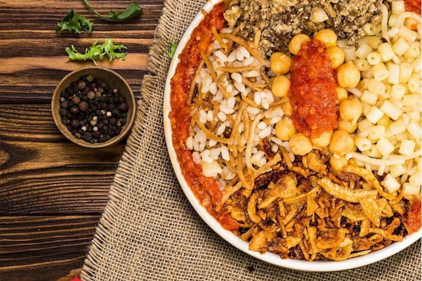 A plate of food with various ingredients like chickpeas, onions, and a tomato-based sauce. 3
