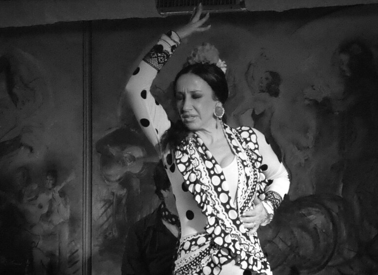 A person in a polka dot dress performing a dance. 2