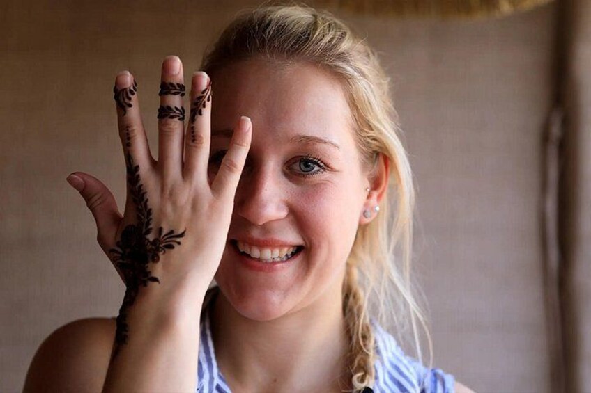 A person with henna designs on their hand. 4