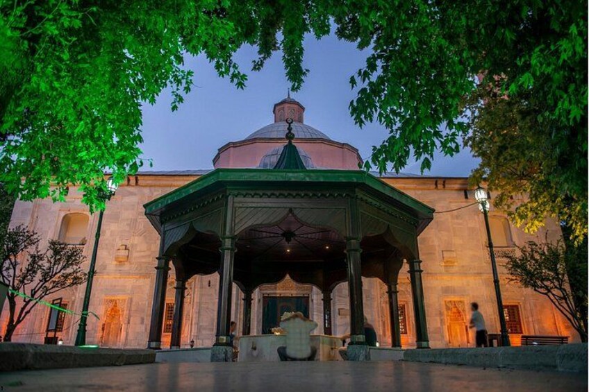 A historical building with a dome and a covered pavilion in front. 5